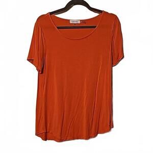 Calvin klein melon colored short sleeve shirt.  Size M